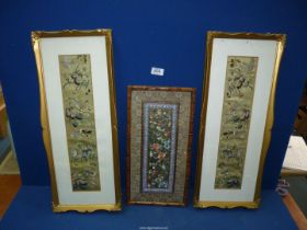 Three pictures of embroidery on silk with birds and butterflies in ornate frames,