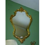 A contemporary shaped gilded framed Wall hanging Mirror, 34 3/4'' high x 19 1/2'' wide approx.