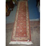 A bordered, patterned and fringed "Royal Keshan" wool Runner in terracotta, 111'' x 27''.