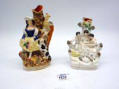 Two Staffordshire spill vases depicting three children reading a book and a girl with a dog and
