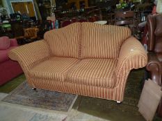 An elegant shaped two seater settee having an arched back,