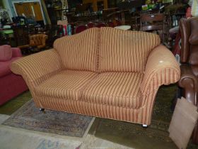An elegant shaped two seater settee having an arched back,