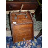 A Mahogany Coal Box having an iron carrying handle and complete with a shovel and metal liner.