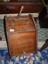 A Mahogany Coal Box having an iron carrying handle and complete with a shovel and metal liner.