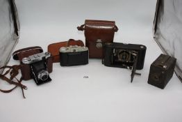 Various Vintage Cameras: A Zeiss Ikon Super Ikonta folding bellows roll film Camera having a