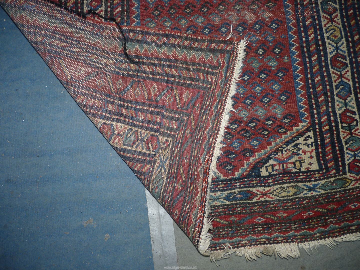 A bordered, patterned and fringed Rug in red, blue and cream, 78'' x 39''. - Image 2 of 2