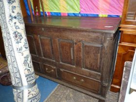 An early 19th century/18th century four panel dark Oak mule chest having raised and fielded panels