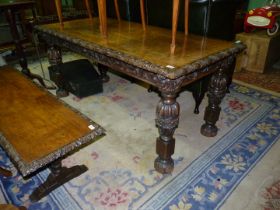 A profusely carved rectangular Oak Table standing on turned and carved legs and with deeply carved