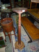 A Mahogany Pedestal having a circular top, a turned pillar and circular base with three feet,