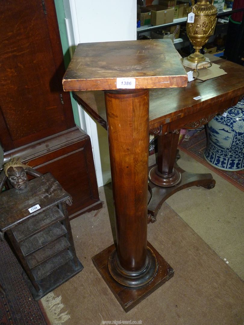 A turned satinwood pillar/pedestal having a square top and base, the top,