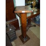 A turned satinwood pillar/pedestal having a square top and base, the top,
