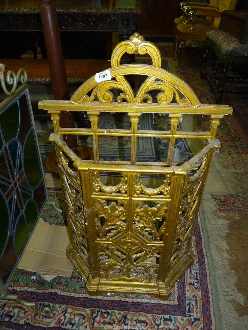 A gold painted cast iron Stick/umbrella Stand decorated with floral swags, foliage, etc.