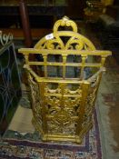 A gold painted cast iron Stick/umbrella Stand decorated with floral swags, foliage, etc.