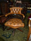 A brown hide upholstered buttoned detailed swivel and tilt Office Armchair,