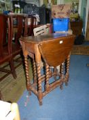 An Oak dropleaf Occasional Table standing on twist legs,