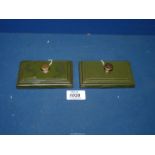 Two antique, solid cast and moulded desk paperweights with brass finials and baize bottoms,