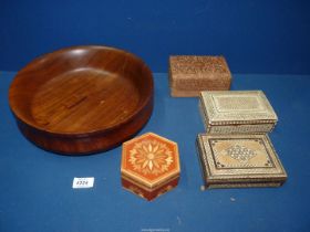 A large wooden fruit bowl, 12" diameter x 3 1/2" high and four inlaid boxes including a spice box.