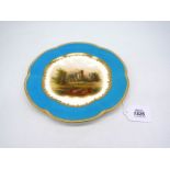 An early 19th century English cabinet plate decorated with a landscape scene and a turquoise rim,