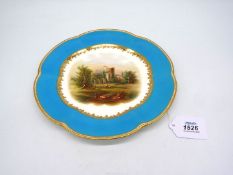 An early 19th century English cabinet plate decorated with a landscape scene and a turquoise rim,