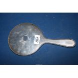 A Silver backed hand Mirror, hallmarks rubbed.