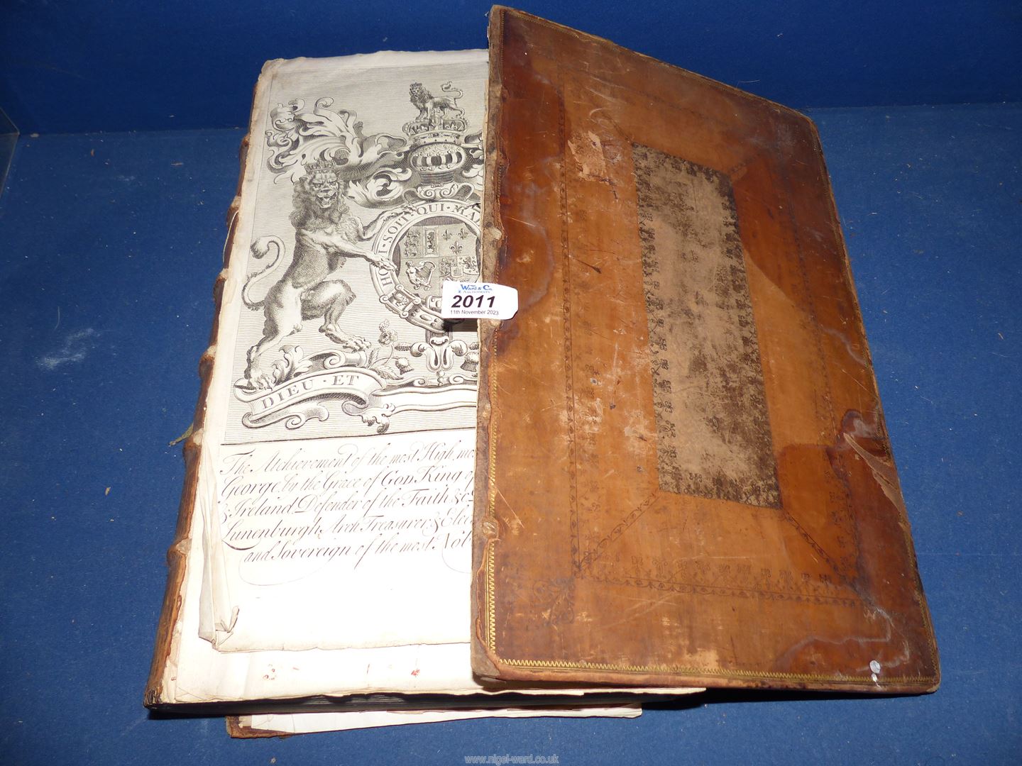 A leather bound book by John Guillim titled A Display of Heraldry, sixth edition, printed by T.W.