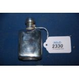 A small Silver hip flask with twist mechanism lock to the lid, hallmarks for Birmingham 1897,