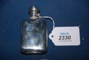 A small Silver hip flask with twist mechanism lock to the lid, hallmarks for Birmingham 1897,
