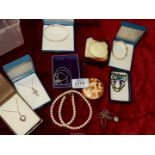 A box of costume jewellery including some silver.