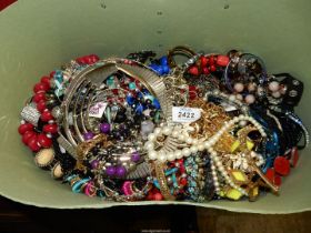 A large green case of costume jewellery including bead necklaces, bracelets, etc.