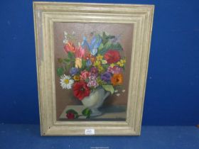 A framed Oil on canvas depicting a still life of flowers in a grey jug,