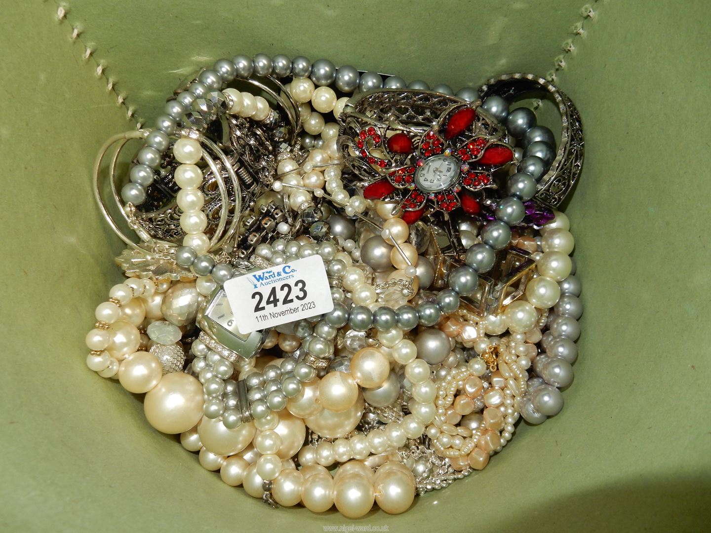 A jewellery box containing costume jewellery, etc.