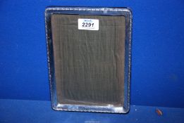 A silver picture frame stamped 1919 (makers mark rubbed), 6 1/4" wide x 8 3/4" high.