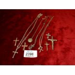 A quantity of silver and white metal chains and crucifixes including one with marcasite,