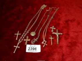 A quantity of silver and white metal chains and crucifixes including one with marcasite,