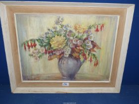 A framed Oil on board depicting a still life of flowers in a jug, signed lower left Dorothy G.