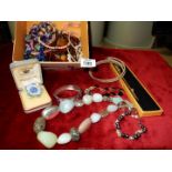 A box of costume jewellery including stone necklaces (amethyst, etc.), bracelets, etc.