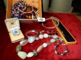 A box of costume jewellery including stone necklaces (amethyst, etc.), bracelets, etc.