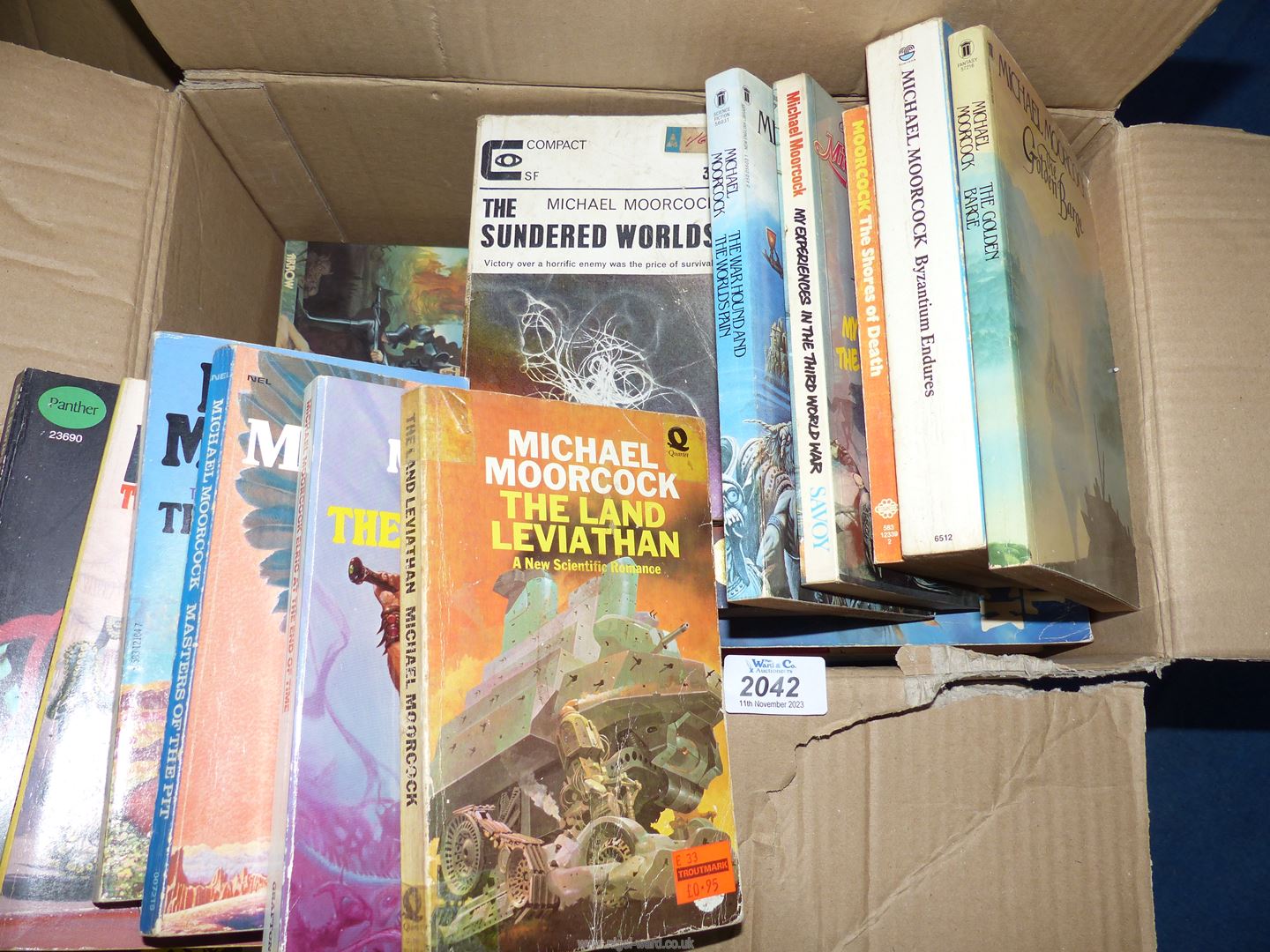 A box of Michael Moorcock paperbacks to include; The Shores of Death, The Golden Barge, etc.