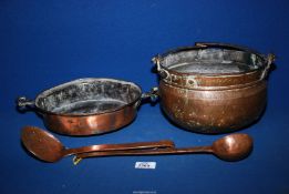 Four copper items; pan with brass handles, cooking pot, ladle and slotted spoon.