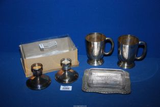 A pair of plated tankards, a pair of Arthur Price plated candle holders and an EPNS butter dish.