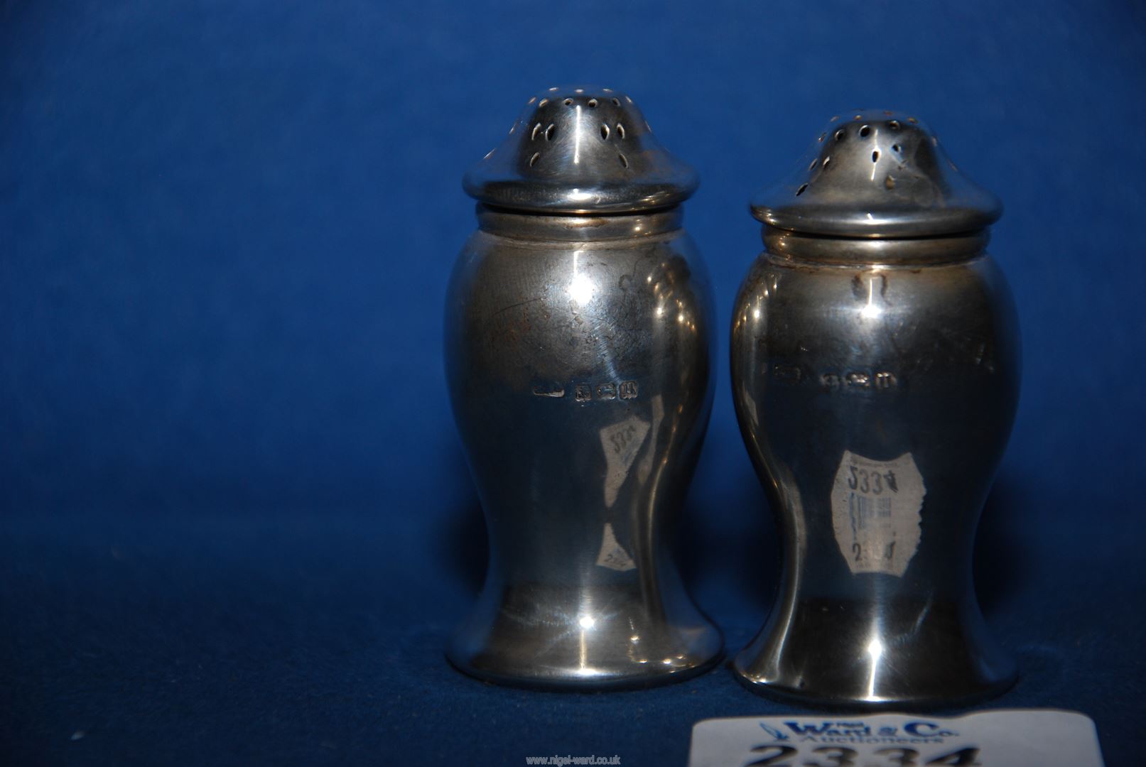 A pair of silver pepper pots, Birmingham 1919, makers mark rubbed, 36.51 grams total. - Image 2 of 2