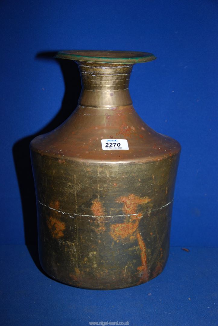 A hammered copper water vessel having brass overlay, 14 1/2" tall.