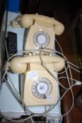 Two dial telephones.