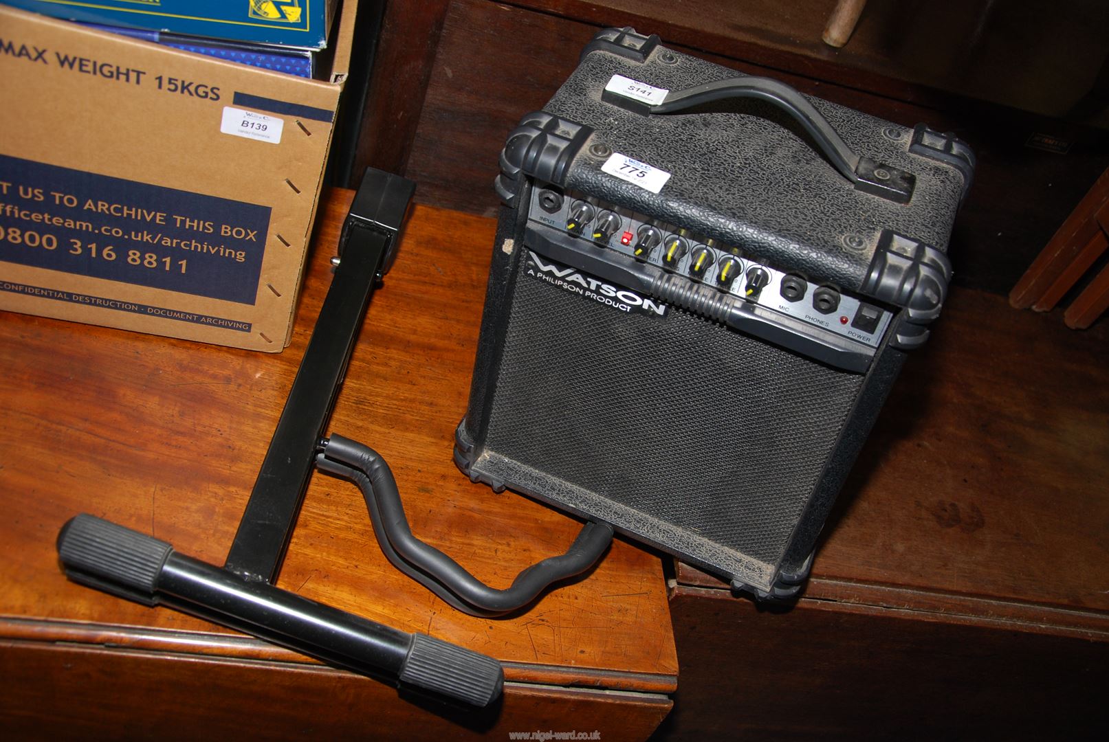 A "Squire" electric guitar by Fender, a small Watson's Amplifier/speaker plus stand.