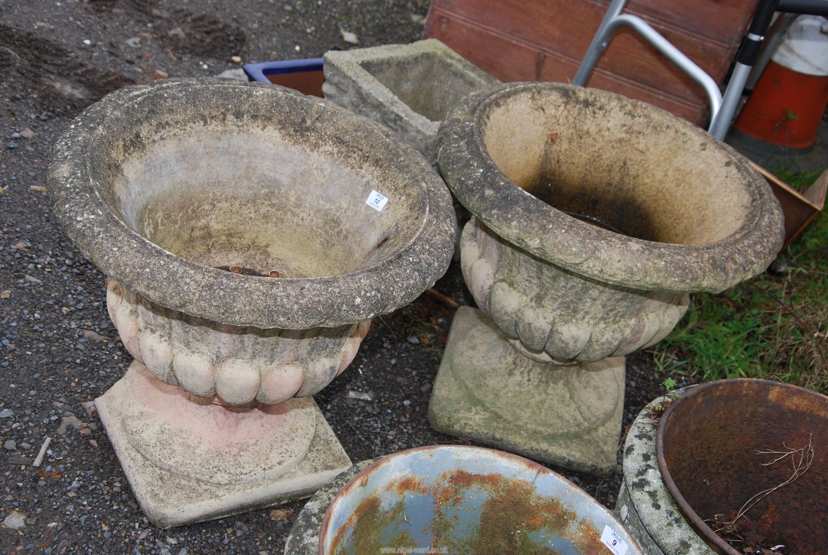 Two urn planters, (slight damage to one base), 21'' wide x 19'' high.