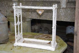 A cast iron stick stand with drip tray, 24'' wide x 10'' deep x 24'' high.
