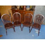 Four stick back kitchen chairs.