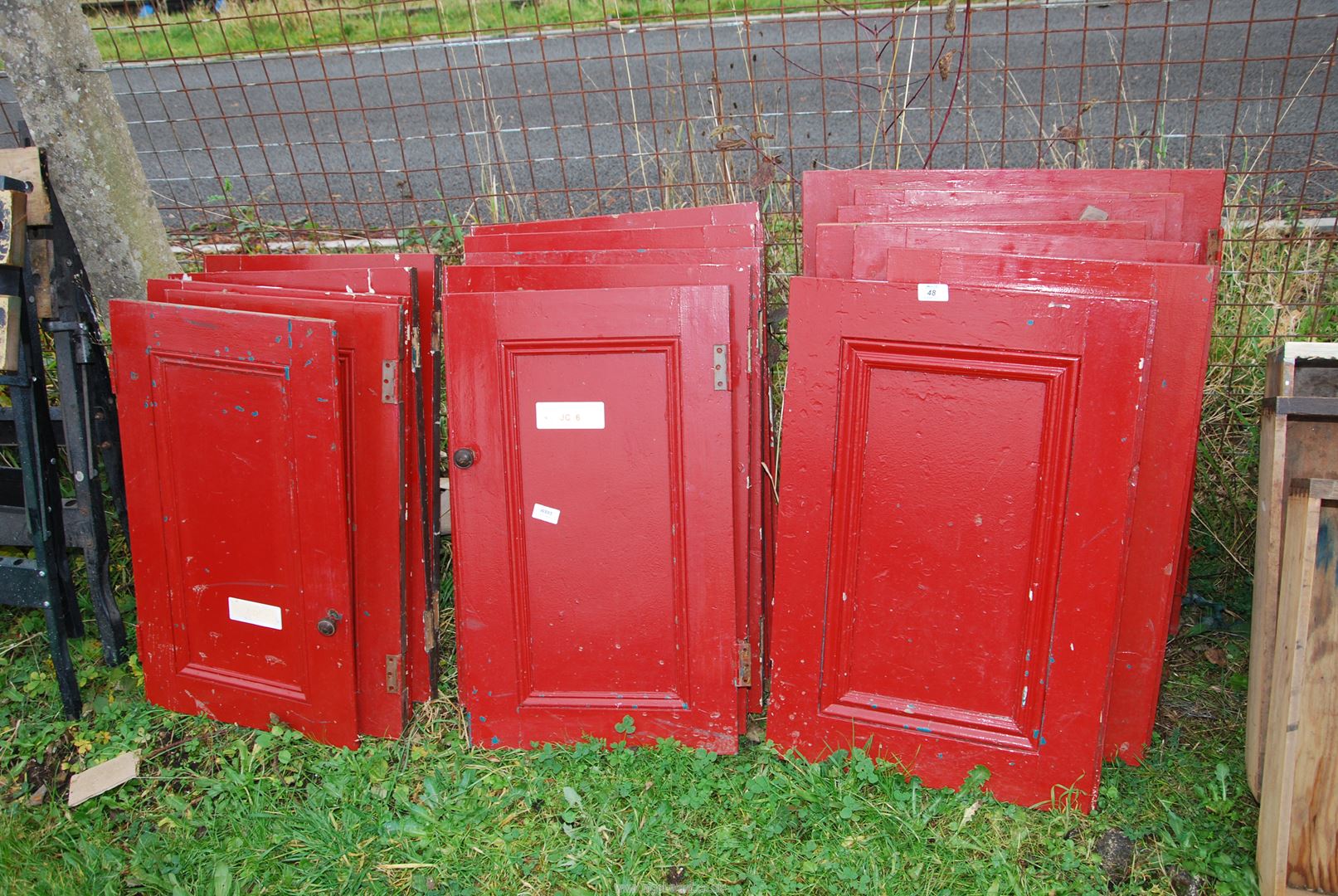 Eighteen painted wood cupboard doors.