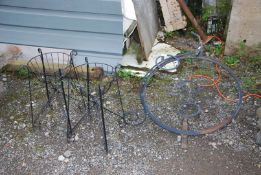A penny farthing pot holder, 30'' high plus two wrought iron plant stands.
