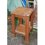 An octagonal table with lower shelf, 18 1/2'' x 31'' high.